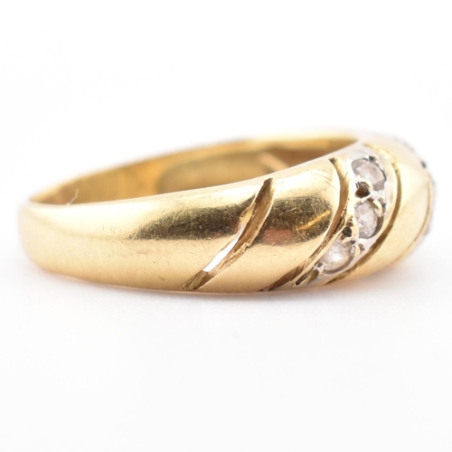 138 - An 18ct gold and CZ dome ring. The 18ct yellow gold dome ring set with three slanted rows of three r... 