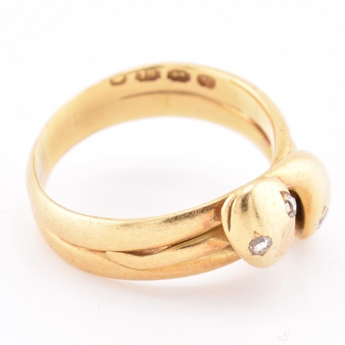 14 - A Victorian hallmarked 18ct gold and diamond snake ring. The 18ct yellow gold ring having two intert... 