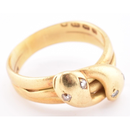 14 - A Victorian hallmarked 18ct gold and diamond snake ring. The 18ct yellow gold ring having two intert... 