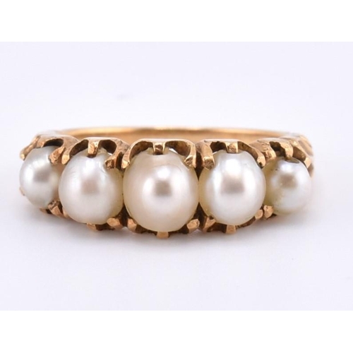 140 - A gold and pearl five stone ring. The gold ring set with five graduating full pearls to decorative s... 