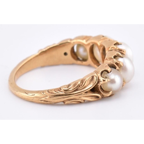 140 - A gold and pearl five stone ring. The gold ring set with five graduating full pearls to decorative s... 