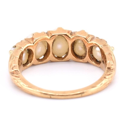 140 - A gold and pearl five stone ring. The gold ring set with five graduating full pearls to decorative s... 