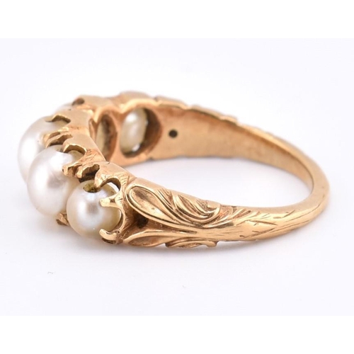 140 - A gold and pearl five stone ring. The gold ring set with five graduating full pearls to decorative s... 