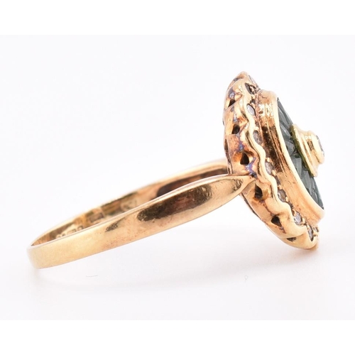 141 - A hallmarked 18ct gold, emerald and diamond ring. The 18ct yellow gold ring having a central bezel s... 