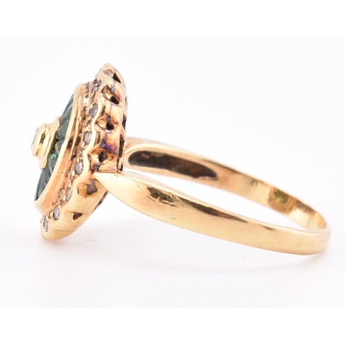 141 - A hallmarked 18ct gold, emerald and diamond ring. The 18ct yellow gold ring having a central bezel s... 