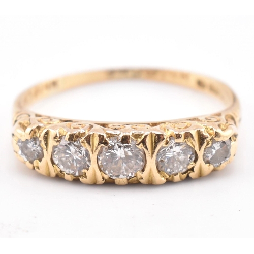 143 - A hallmarked 18ct gold and diamond five stone ring. The 18ct yellow gold ring set with five graduati... 