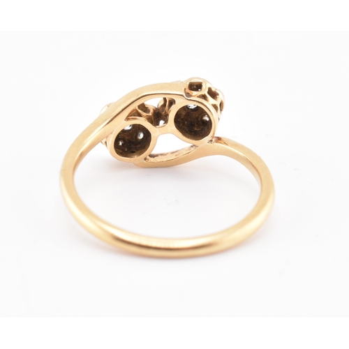 146 - An 18ct gold and diamond crossover ring. The 18ct yellow gold ring having seven round brilliant cut ... 