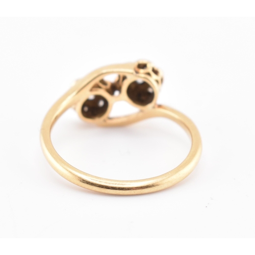 146 - An 18ct gold and diamond crossover ring. The 18ct yellow gold ring having seven round brilliant cut ... 