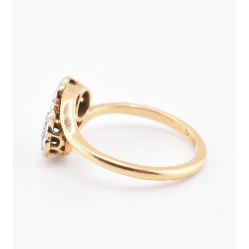 146 - An 18ct gold and diamond crossover ring. The 18ct yellow gold ring having seven round brilliant cut ... 