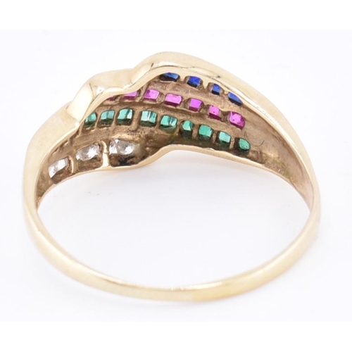 147 - A 9ct gold diamond, ruby, emerald and sapphire ring. The 9ct yellow gold ring set with a row of six ... 