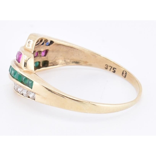 147 - A 9ct gold diamond, ruby, emerald and sapphire ring. The 9ct yellow gold ring set with a row of six ... 