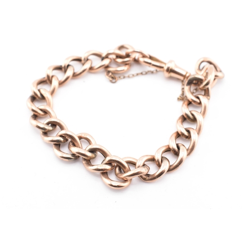 149 - A hallmarked 9ct gold curb link bracelet. The 9ct rose gold curb link bracelet having a dog lead cla... 