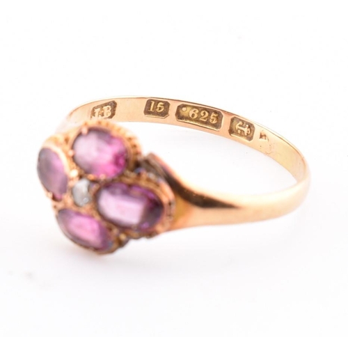 15 - A Victorian hallmarked 15ct gold, garnet and diamond flower ring. The Victorian gold ring having a r... 