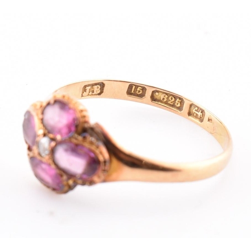 15 - A Victorian hallmarked 15ct gold, garnet and diamond flower ring. The Victorian gold ring having a r... 