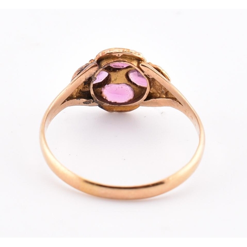 15 - A Victorian hallmarked 15ct gold, garnet and diamond flower ring. The Victorian gold ring having a r... 