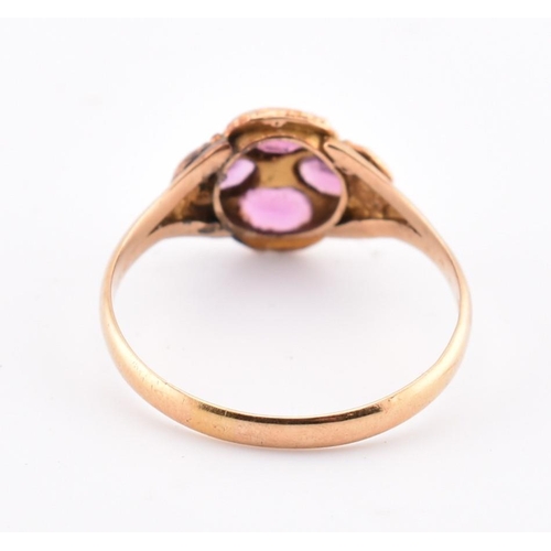 15 - A Victorian hallmarked 15ct gold, garnet and diamond flower ring. The Victorian gold ring having a r... 