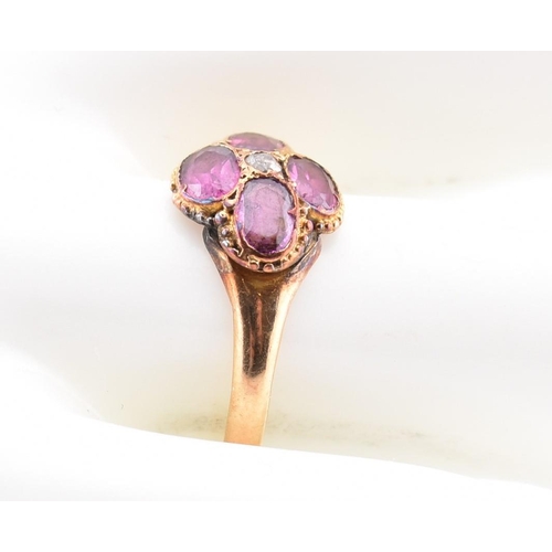 15 - A Victorian hallmarked 15ct gold, garnet and diamond flower ring. The Victorian gold ring having a r... 