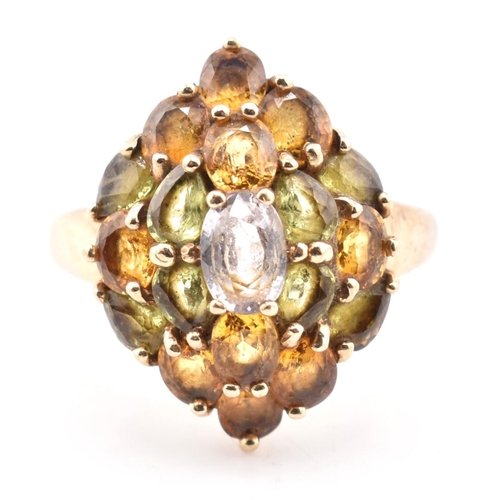 153 - A hallmarked 9ct gold and sapphire cluster ring. The yellow gold ring set with a central oval cut sa... 