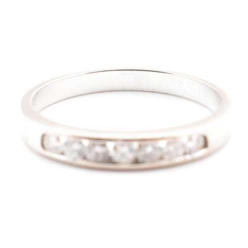 157a - A hallmarked 9ct white gold and diamond half eternity ring. The 9ct white gold ring having seven cha... 