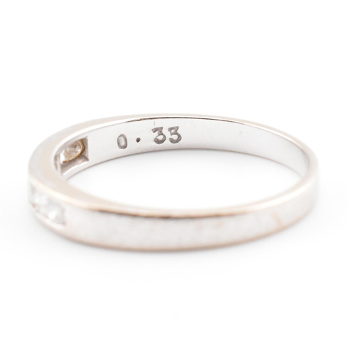 157a - A hallmarked 9ct white gold and diamond half eternity ring. The 9ct white gold ring having seven cha... 