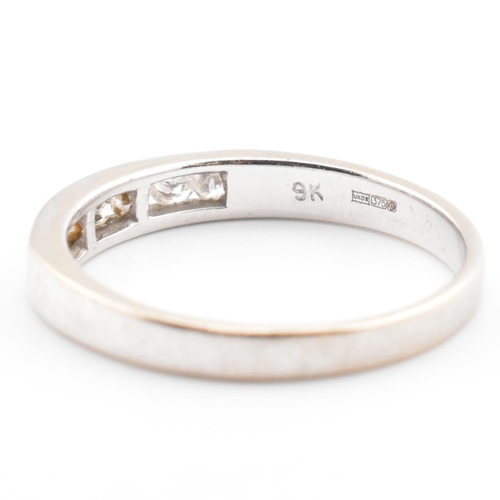 157a - A hallmarked 9ct white gold and diamond half eternity ring. The 9ct white gold ring having seven cha... 