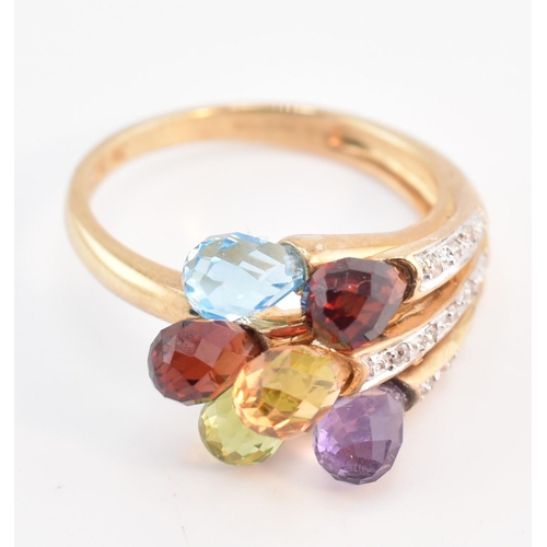 158 - A hallmarked 9ct gold multi-stone crossover ring. The 9ct yellow gold ring having faceted garnet, am... 