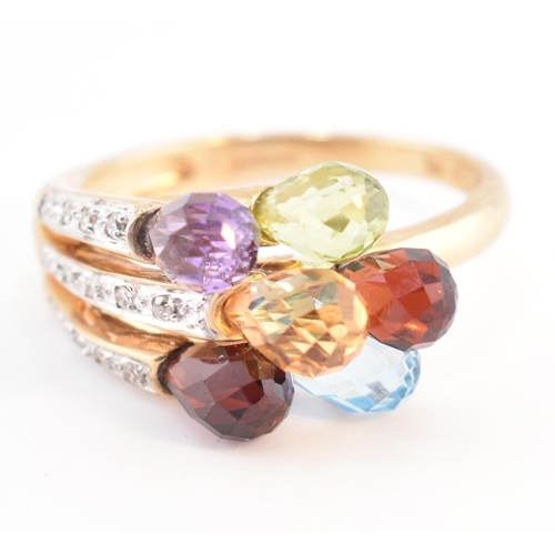 158 - A hallmarked 9ct gold multi-stone crossover ring. The 9ct yellow gold ring having faceted garnet, am... 