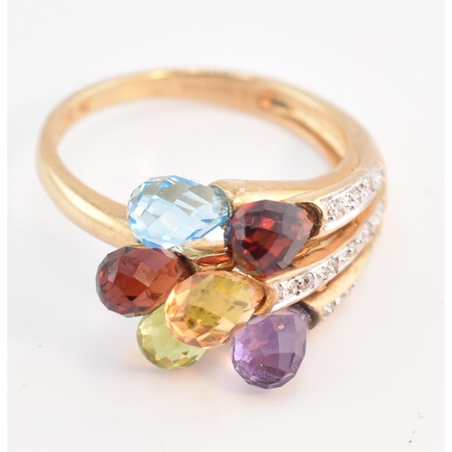 158 - A hallmarked 9ct gold multi-stone crossover ring. The 9ct yellow gold ring having faceted garnet, am... 