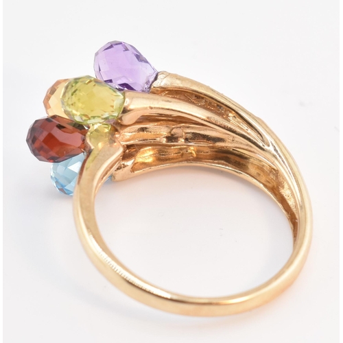 158 - A hallmarked 9ct gold multi-stone crossover ring. The 9ct yellow gold ring having faceted garnet, am... 