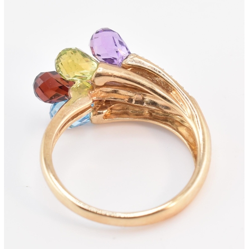 158 - A hallmarked 9ct gold multi-stone crossover ring. The 9ct yellow gold ring having faceted garnet, am... 