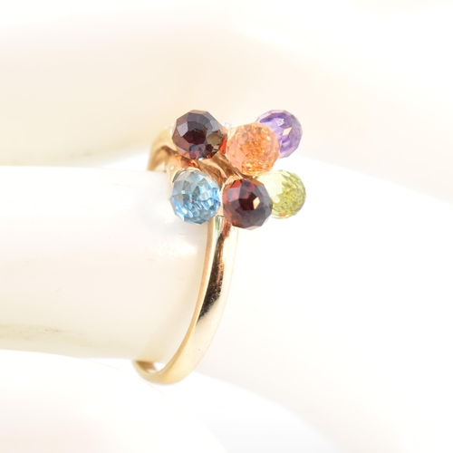 158 - A hallmarked 9ct gold multi-stone crossover ring. The 9ct yellow gold ring having faceted garnet, am... 