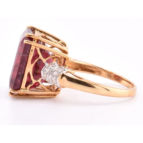 160 - A hallmarked 18ct gold pink tourmaline and diamond ring. The 18ct yellow gold ring set with a centra... 