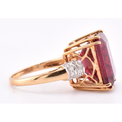 160 - A hallmarked 18ct gold pink tourmaline and diamond ring. The 18ct yellow gold ring set with a centra... 