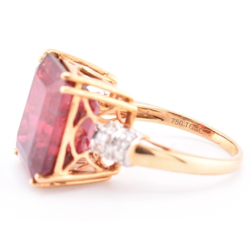 160 - A hallmarked 18ct gold pink tourmaline and diamond ring. The 18ct yellow gold ring set with a centra... 