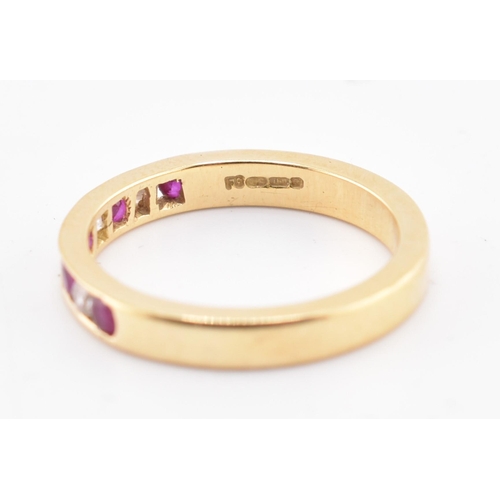 161 - A hallmarked 18ct gold ruby and diamond ring. The 18ct yellow gold ring having five channel set roun... 