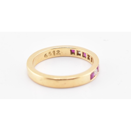 161 - A hallmarked 18ct gold ruby and diamond ring. The 18ct yellow gold ring having five channel set roun... 