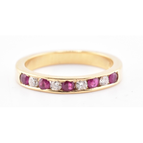 161 - A hallmarked 18ct gold ruby and diamond ring. The 18ct yellow gold ring having five channel set roun... 