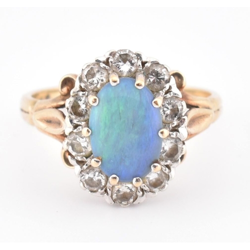 166 - A hallmarked 9ct gold, opal and diamond cluster ring. The 9ct yellow gold ring set with a central ov... 