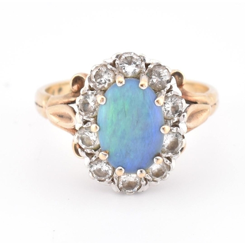 166 - A hallmarked 9ct gold, opal and diamond cluster ring. The 9ct yellow gold ring set with a central ov... 