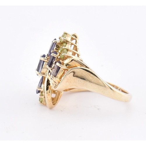 168 - A hallmarked 9ct gold peridot and iolite cluster ring. The 9ct yellow gold ring set with four oval c... 