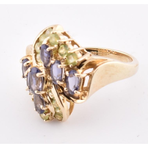 168 - A hallmarked 9ct gold peridot and iolite cluster ring. The 9ct yellow gold ring set with four oval c... 