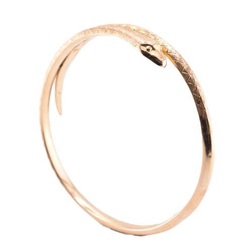 17 - A 19th-century hallmarked 9ct gold snake bangle. The bangle with textured and etched body. Hallmarke... 