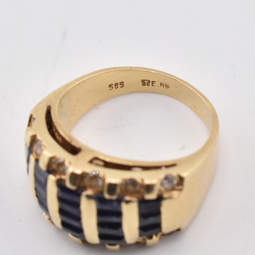 172 - A 14ct gold blue and white sapphire dome ring. The yellow gold ring five rows of calibre blue sapphi... 