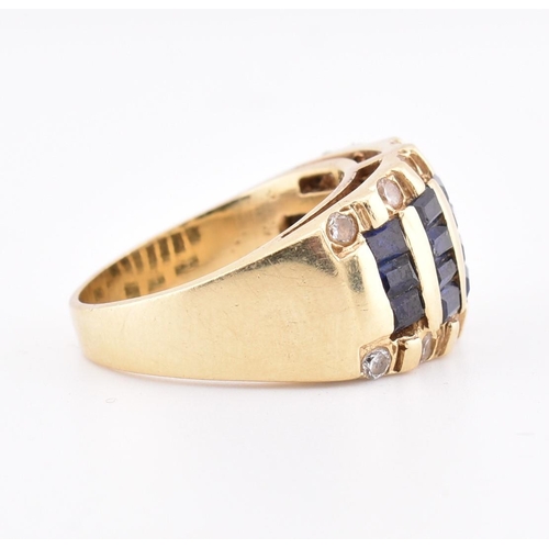 172 - A 14ct gold blue and white sapphire dome ring. The yellow gold ring five rows of calibre blue sapphi... 