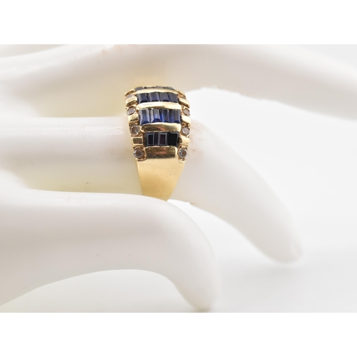 172 - A 14ct gold blue and white sapphire dome ring. The yellow gold ring five rows of calibre blue sapphi... 