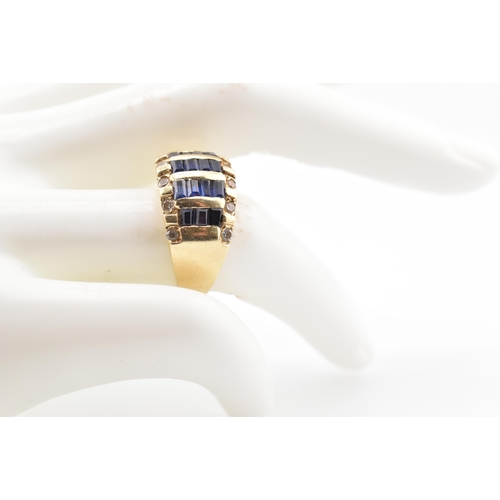 172 - A 14ct gold blue and white sapphire dome ring. The yellow gold ring five rows of calibre blue sapphi... 