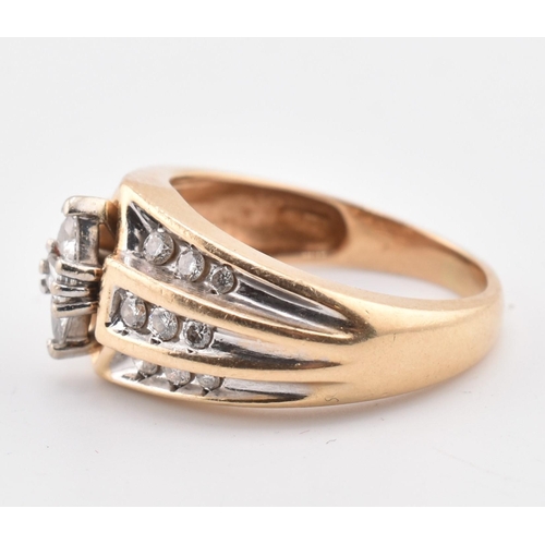 177 - A gold and diamond fancy cluster ring. The yellow gold ring set with a central east-west baguette cu... 