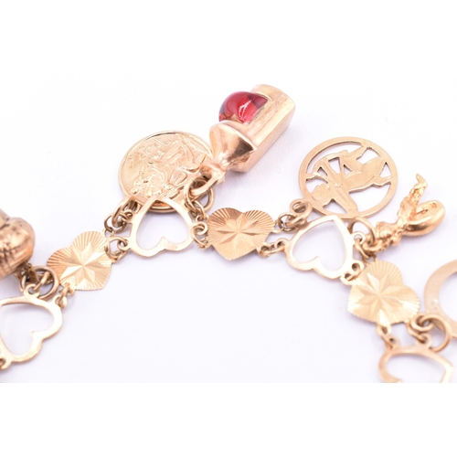 18 - A hallmarked 9ct gold heart link chain charm bracelet. The 9ct gold heart link chain bracelet strung... 