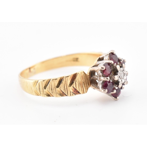 185 - An 18ct gold ruby and diamond cluster ring. The 18ct yellow gold ring having a central illusion set ... 