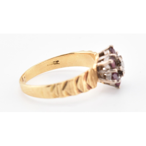 185 - An 18ct gold ruby and diamond cluster ring. The 18ct yellow gold ring having a central illusion set ... 